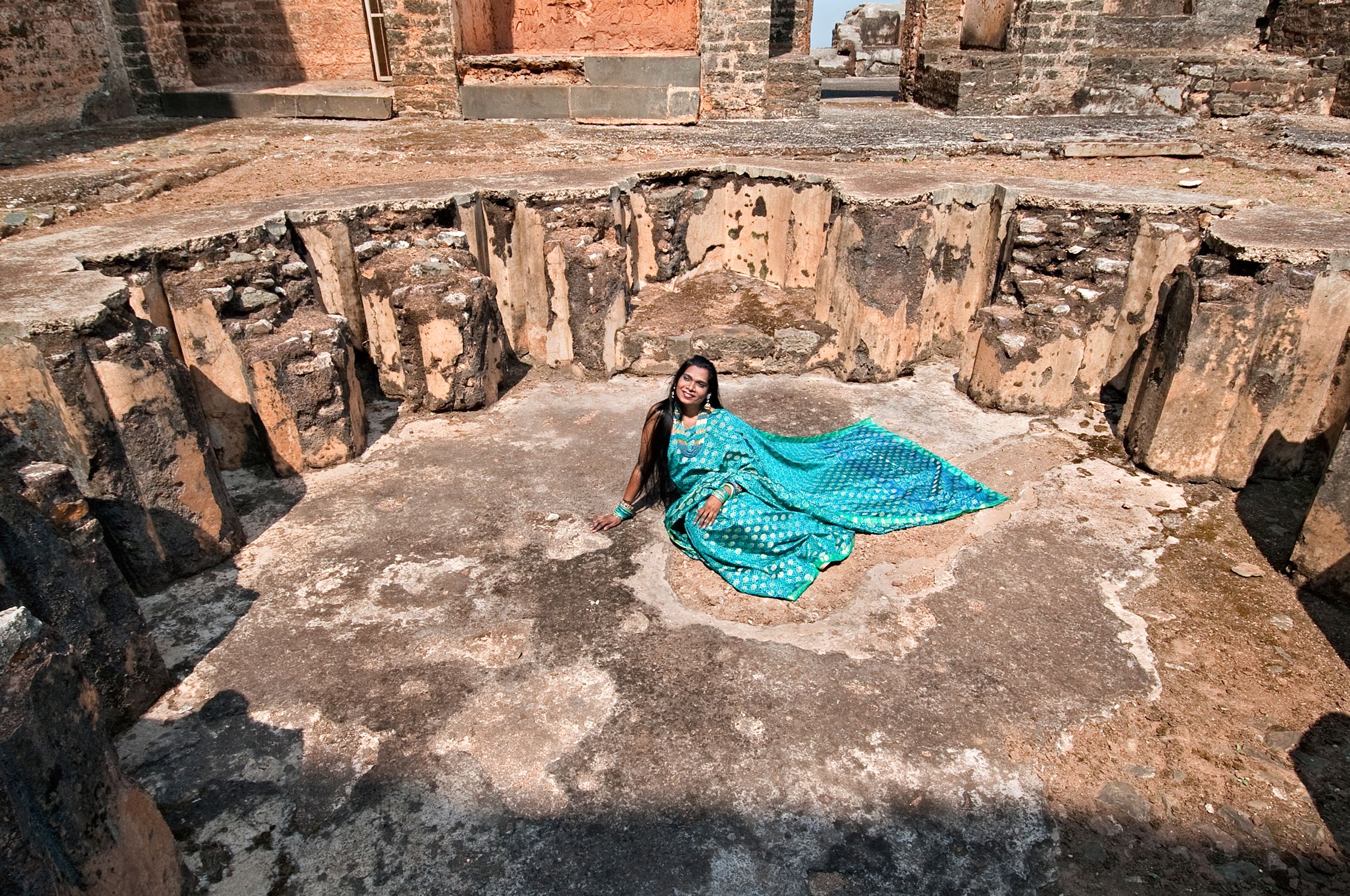 Artistic portrait of Olga B. Aaron against the stone walls of Tarkash Mahal