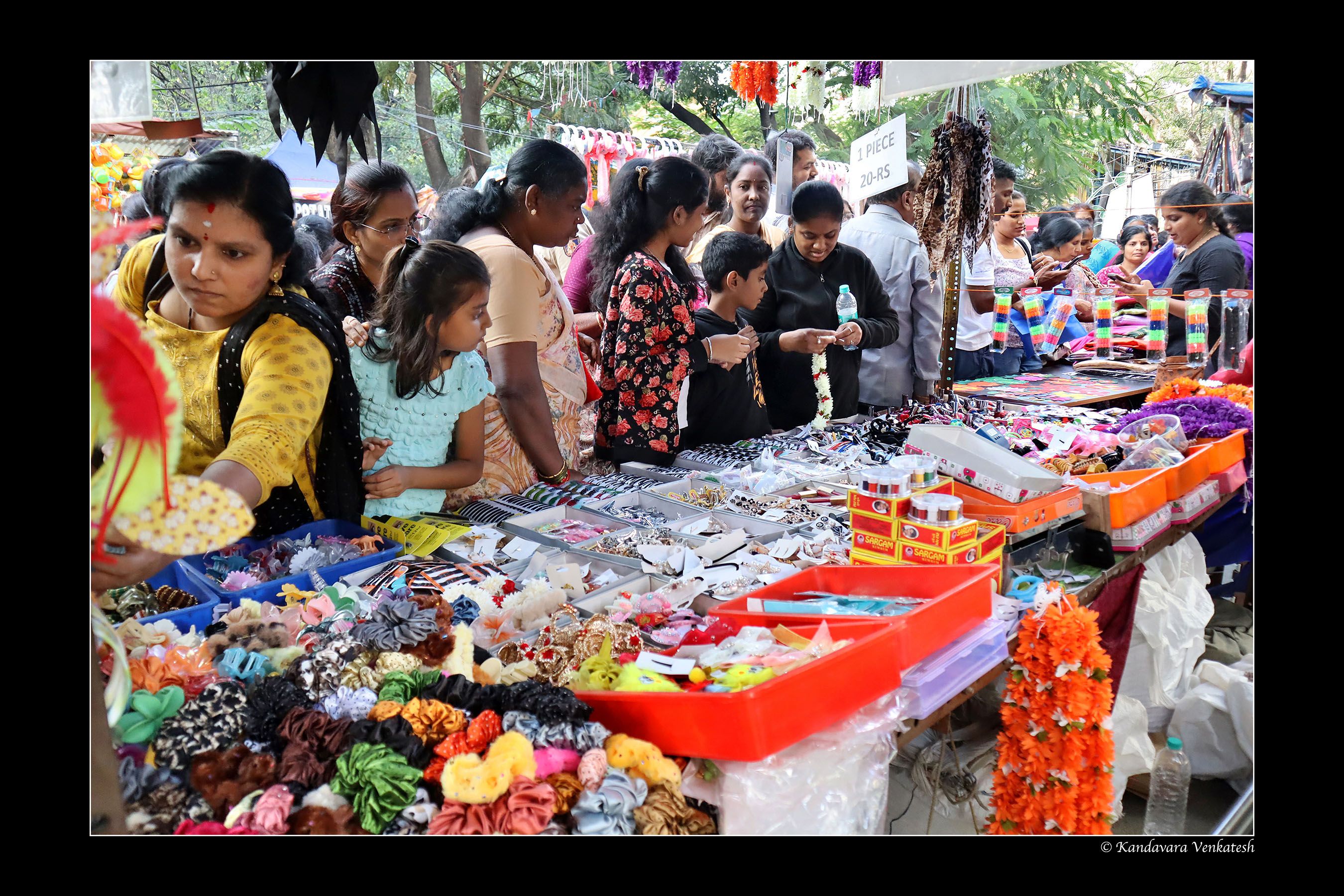 Vendor selling roasted groundnuts under lantern light
